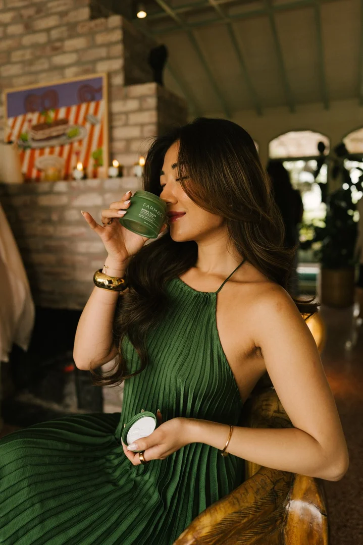 Guest in a green dress at Flamingo Estate — Farmacy Beauty